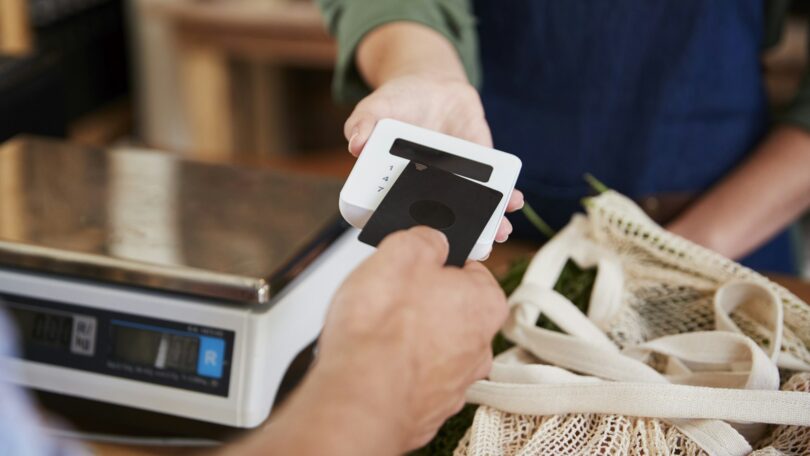 Customer Making Contactless Payment For Shopping At Checkout Of Grocery Store